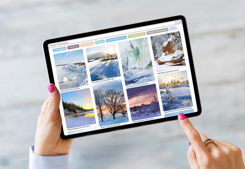 Person Browsing Destinations Online on Tablet